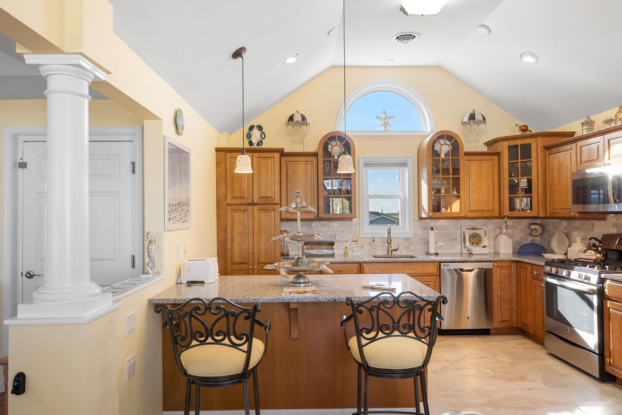 704 South Commonwealth Avenue Strathmere, NJ 08248 - Photo 23 of 50 a large kitchen with a table and chairs