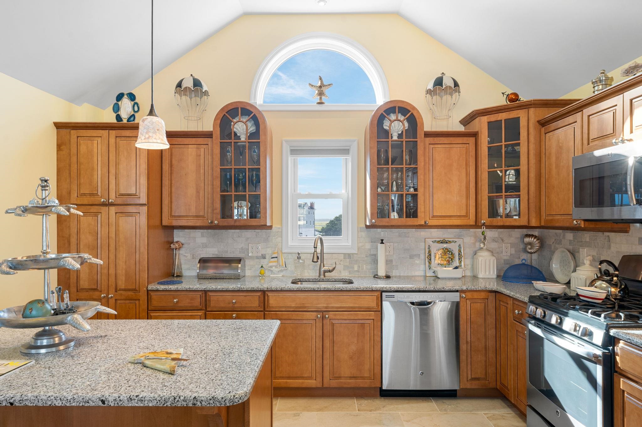 704 South Commonwealth Avenue Strathmere, NJ 08248 - Photo 24 of 50 a kitchen with stainless steel appliances granite countertop a stove a sink and a wooden cabinets