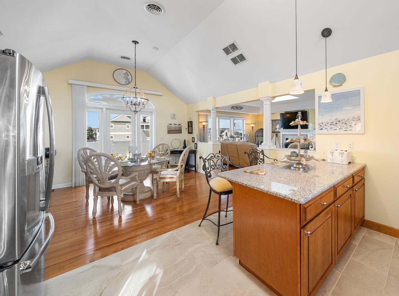 704 South Commonwealth Avenue Strathmere, NJ 08248 - Photo 26 of 50 a kitchen with stainless steel appliances kitchen island granite countertop a table chairs and a sink