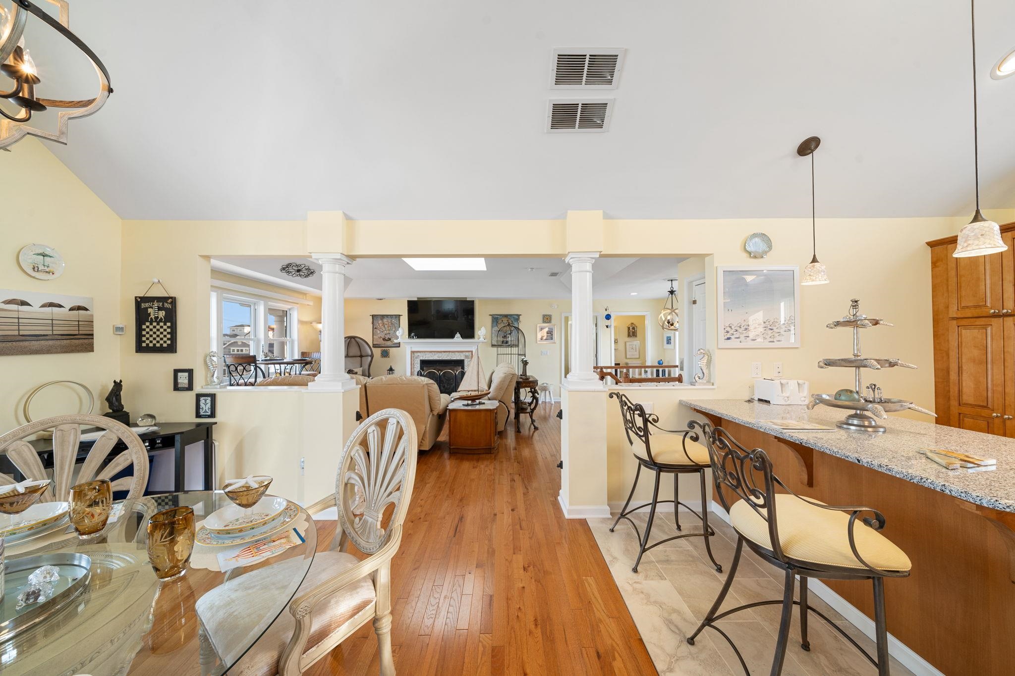 704 South Commonwealth Avenue Strathmere, NJ 08248 - Photo 27 of 50 a view of a kitchen with kitchen island stainless steel appliances refrigerator stove and wooden floor