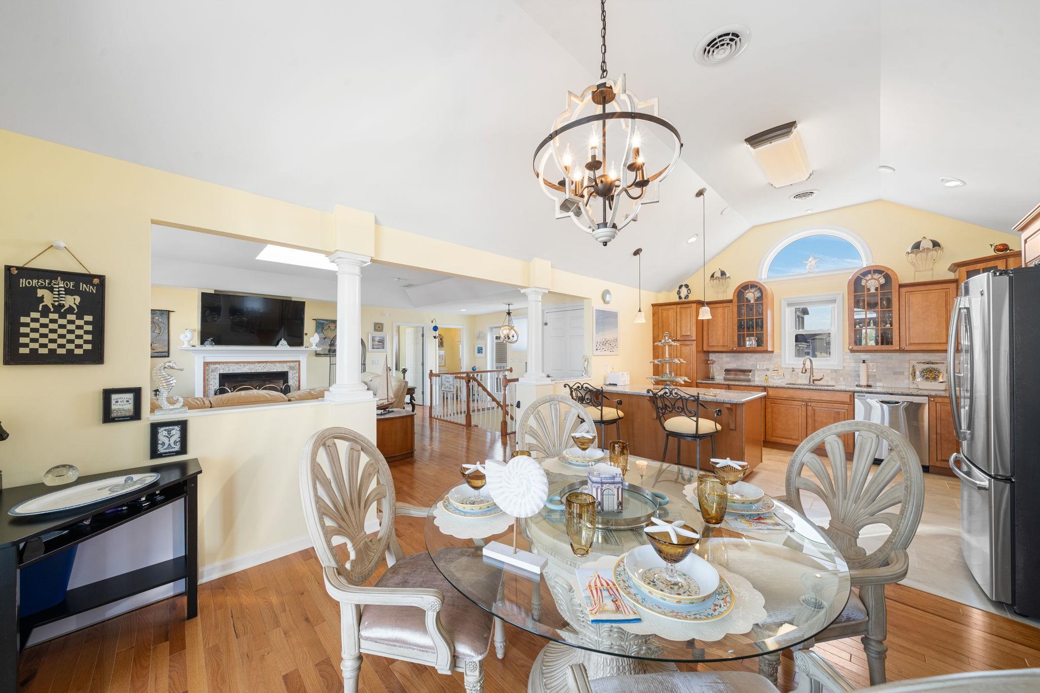 704 South Commonwealth Avenue Strathmere, NJ 08248 - Photo 29 of 50 a view of a dining room with furniture a chandelier and wooden floor