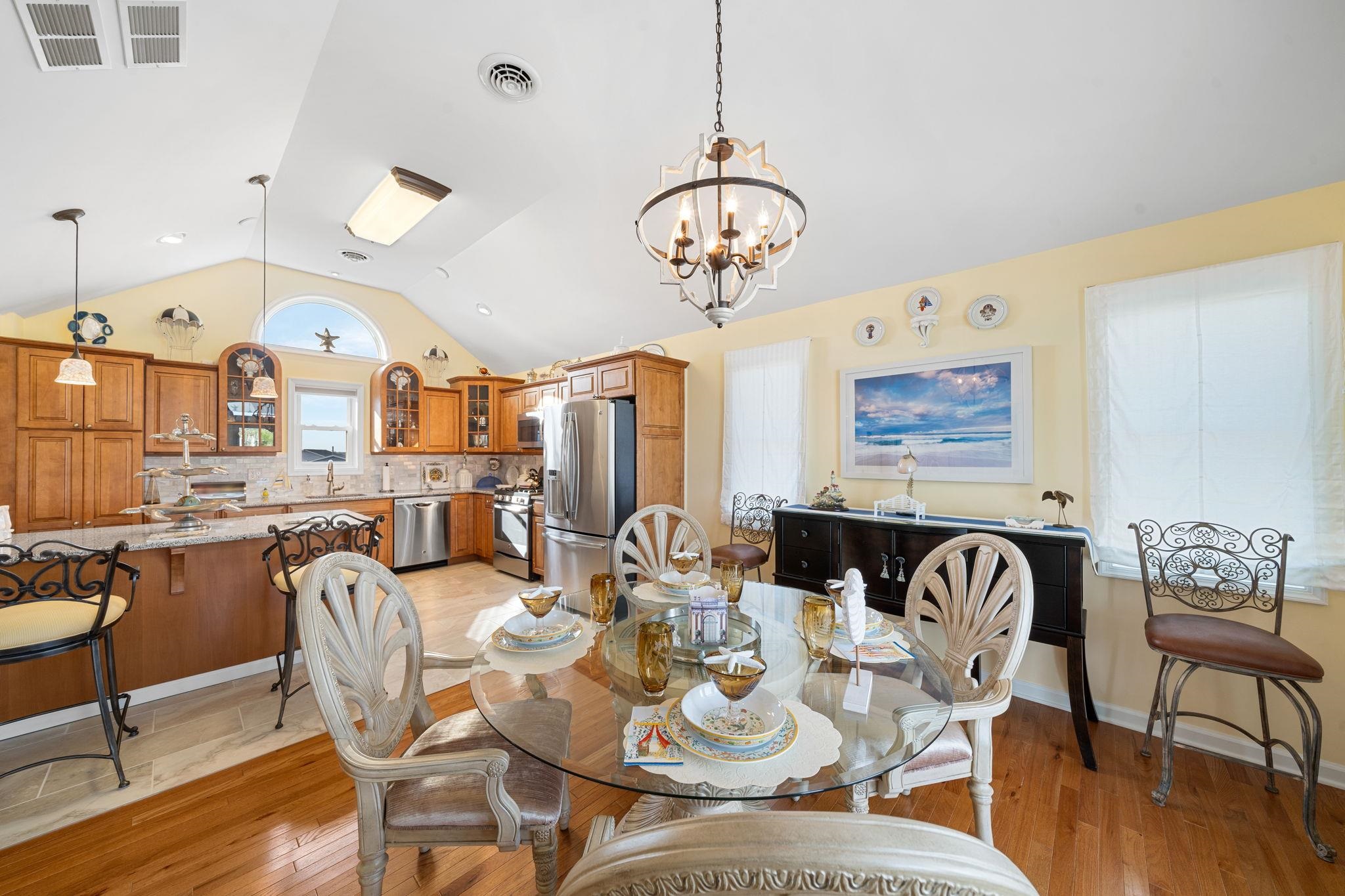 704 South Commonwealth Avenue Strathmere, NJ 08248 - Photo 31 of 50 a view of a dining room with furniture wooden floor and chandelier