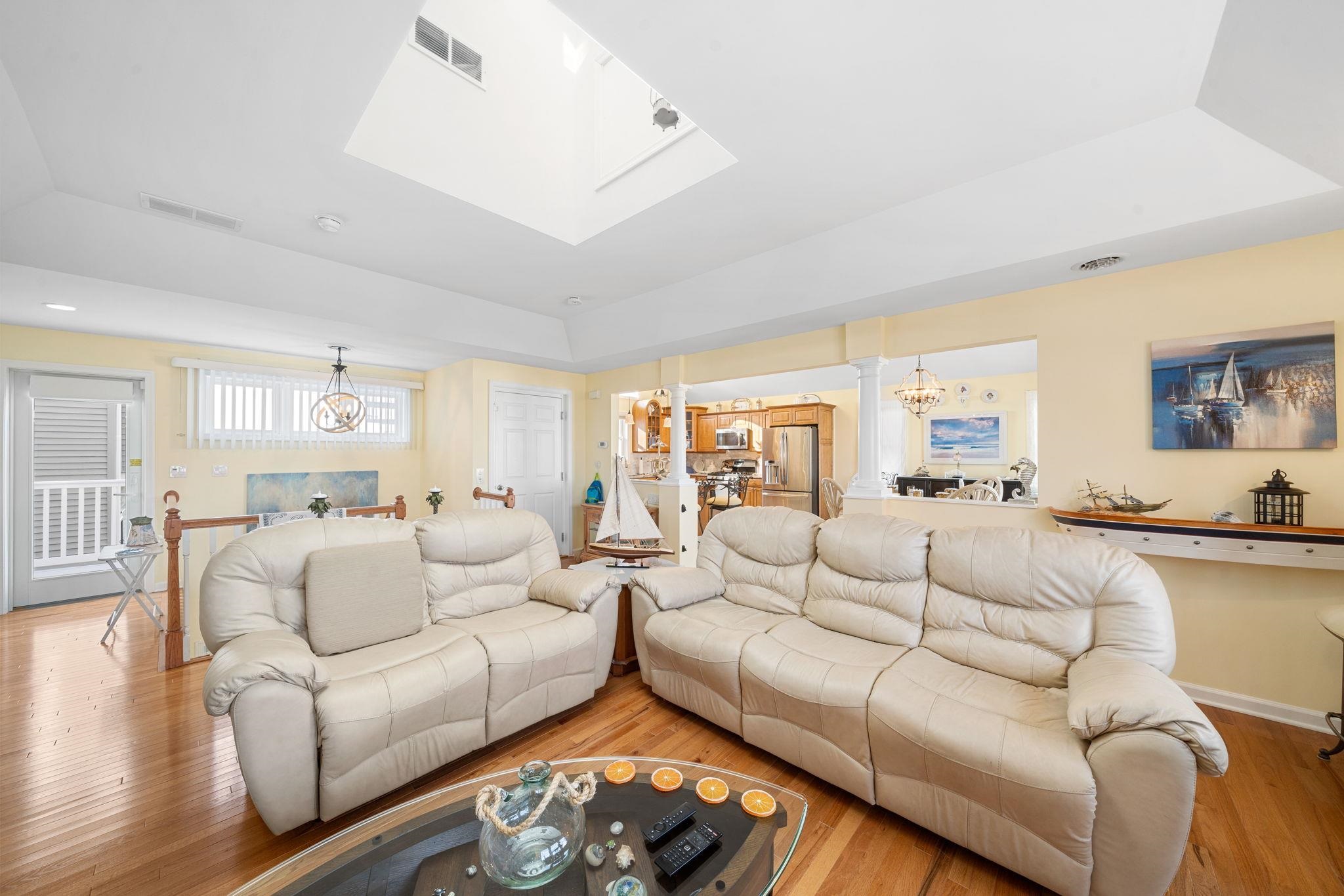 704 South Commonwealth Avenue Strathmere, NJ 08248 - Photo 32 of 50 a living room with furniture white walls and a table