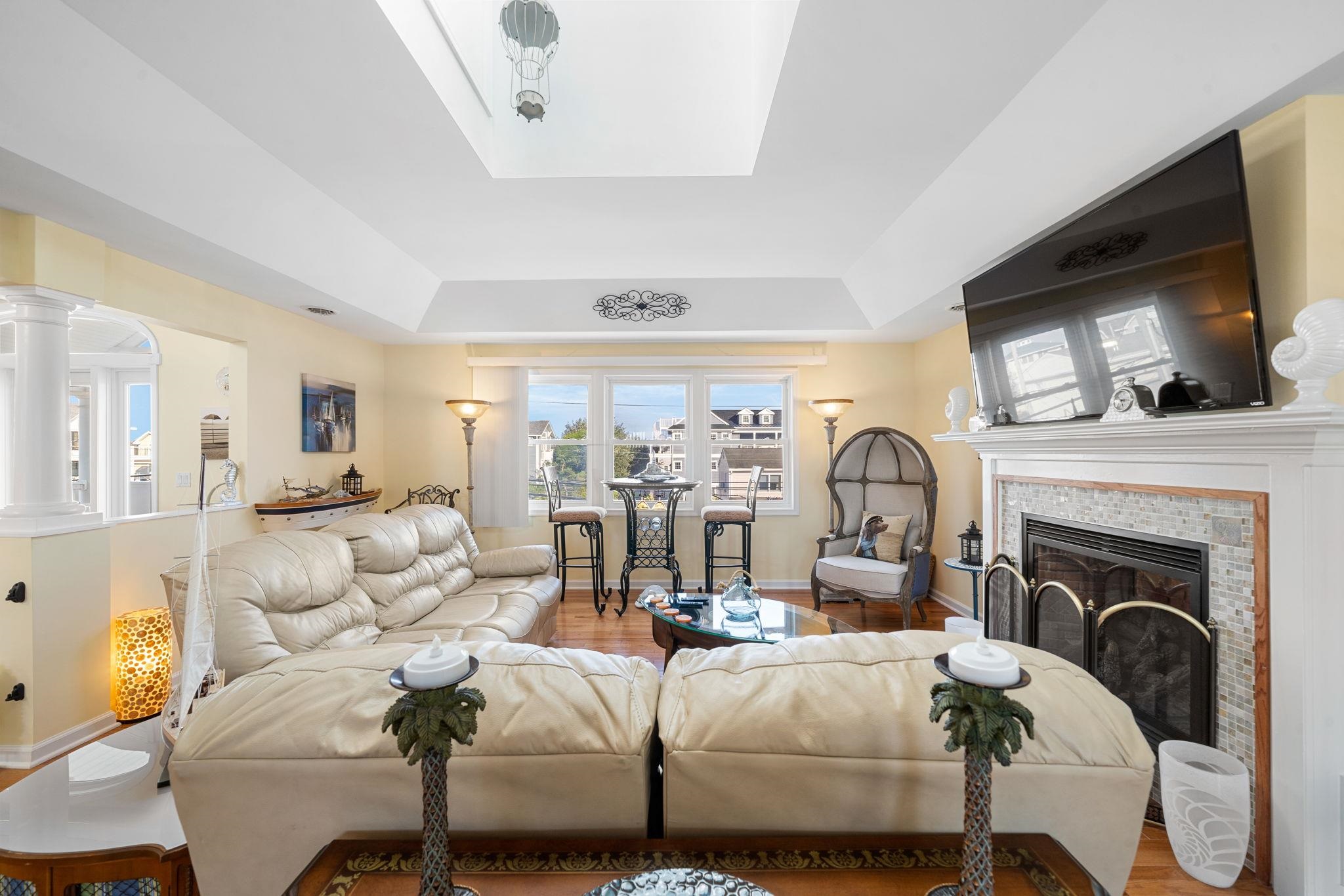 704 South Commonwealth Avenue Strathmere, NJ 08248 - Photo 34 of 50 a living room with furniture fireplace and flat screen tv