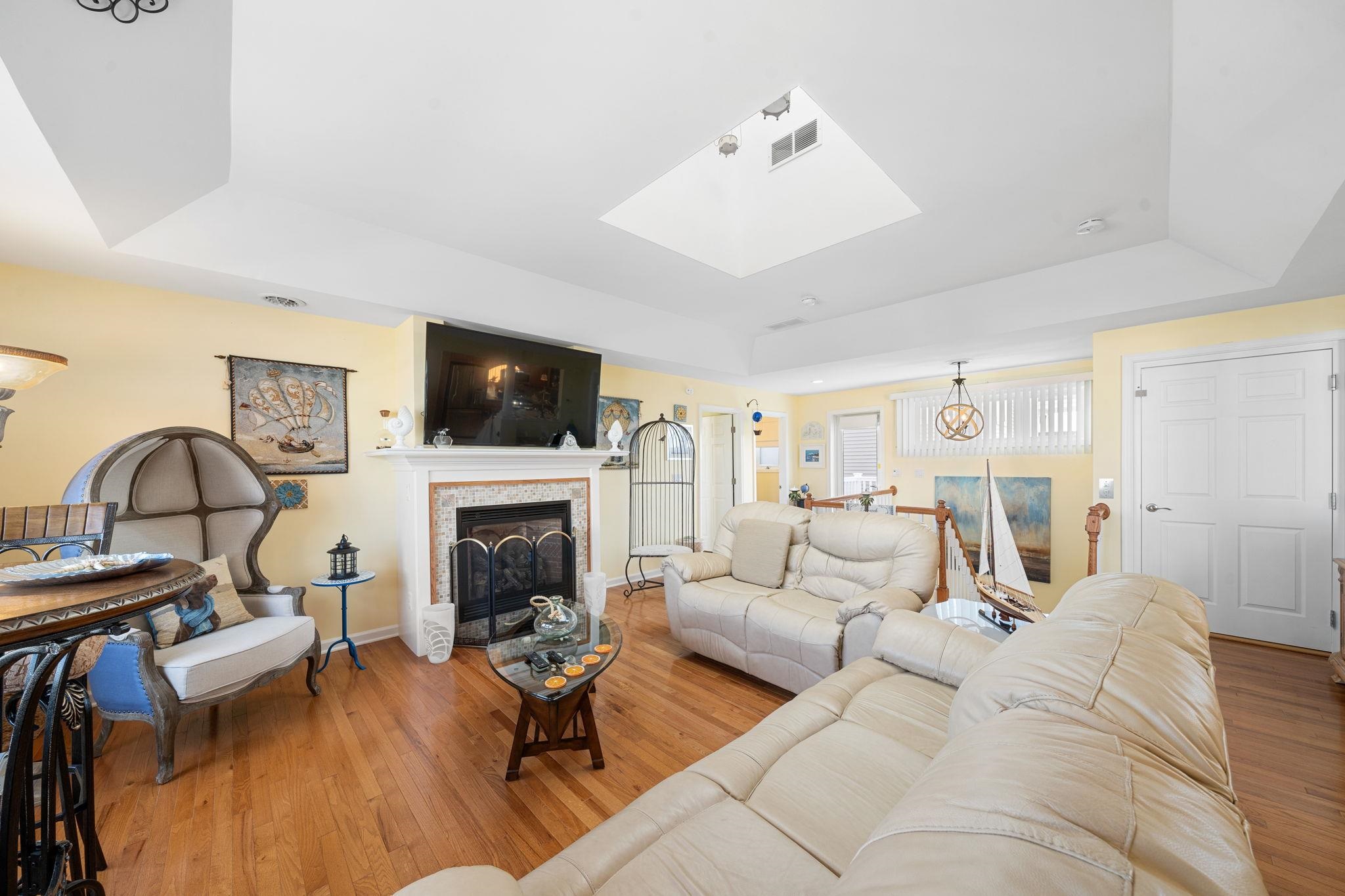 704 South Commonwealth Avenue Strathmere, NJ 08248 - Photo 35 of 50 a living room with furniture a fireplace and a flat screen tv