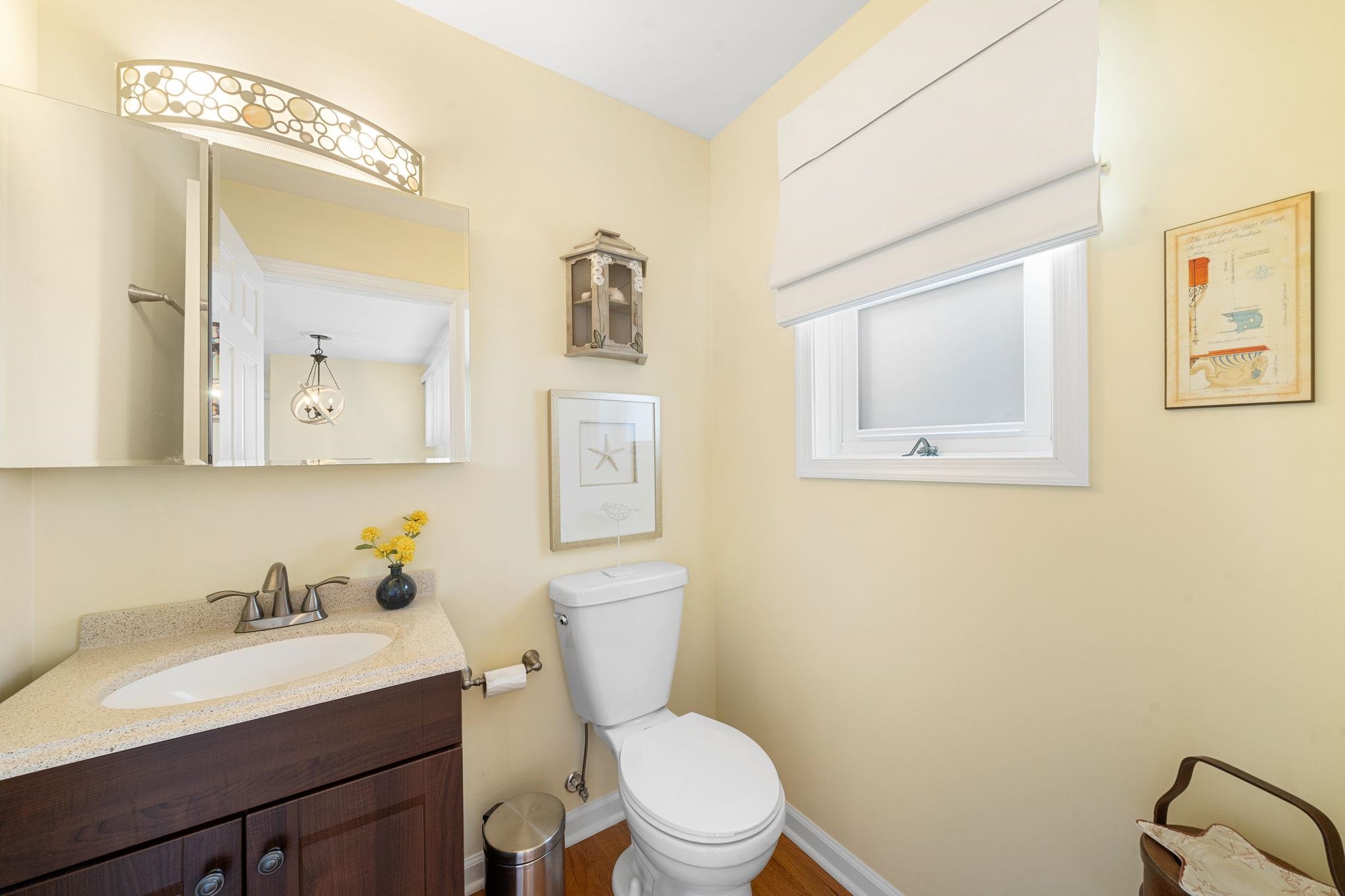 704 South Commonwealth Avenue Strathmere, NJ 08248 - Photo 38 of 50 a bathroom with a toilet a sink and mirror