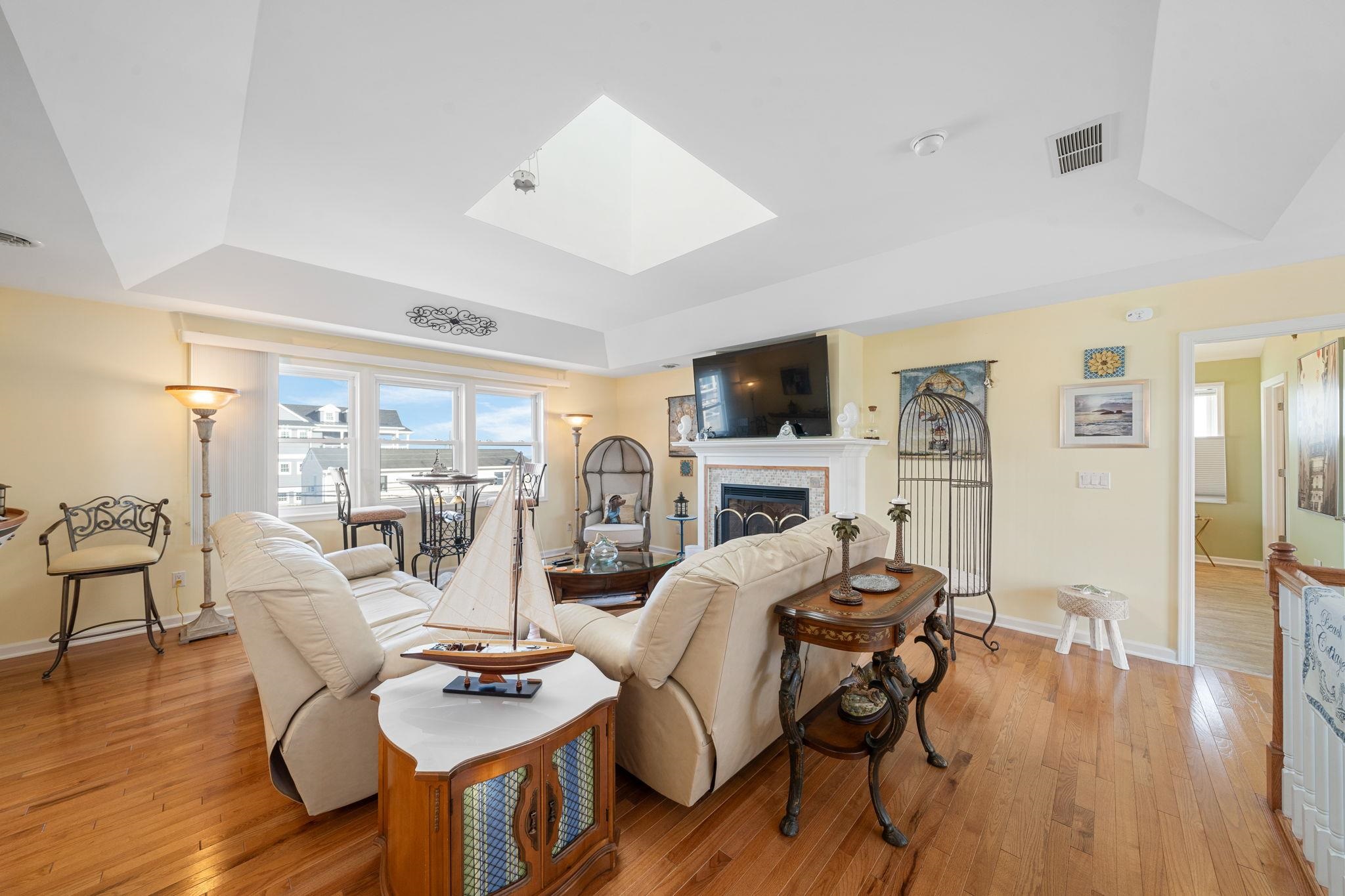 704 South Commonwealth Avenue Strathmere, NJ 08248 - Photo 39 of 50 a living room with furniture a flat screen tv and wooden floor