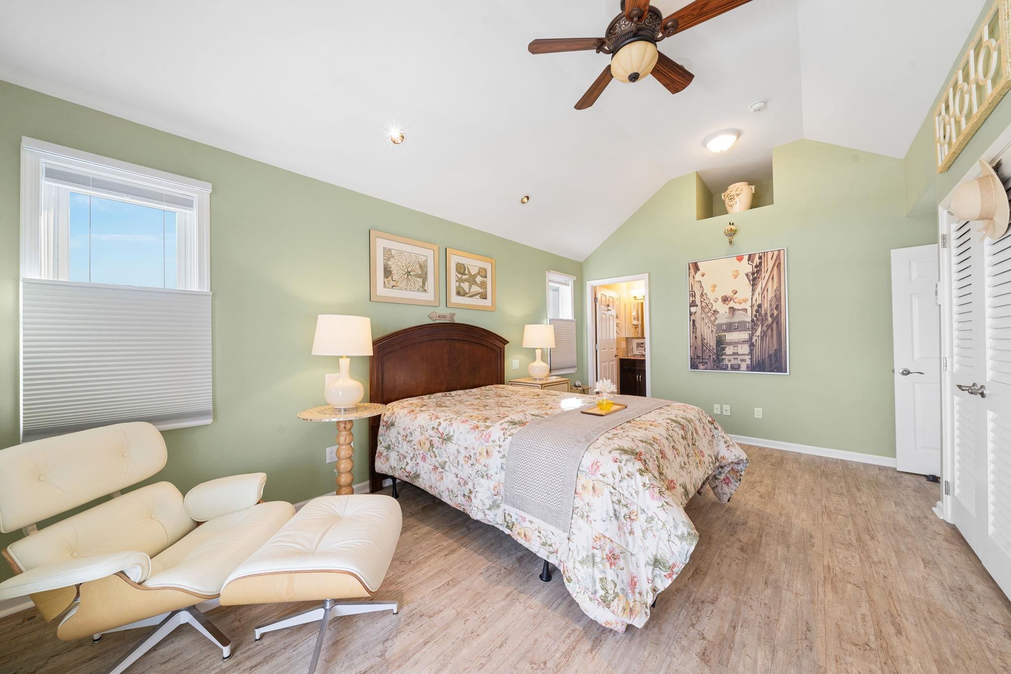 704 South Commonwealth Avenue Strathmere, NJ 08248 - Photo 40 of 50 a bedroom with a bed and wooden floor