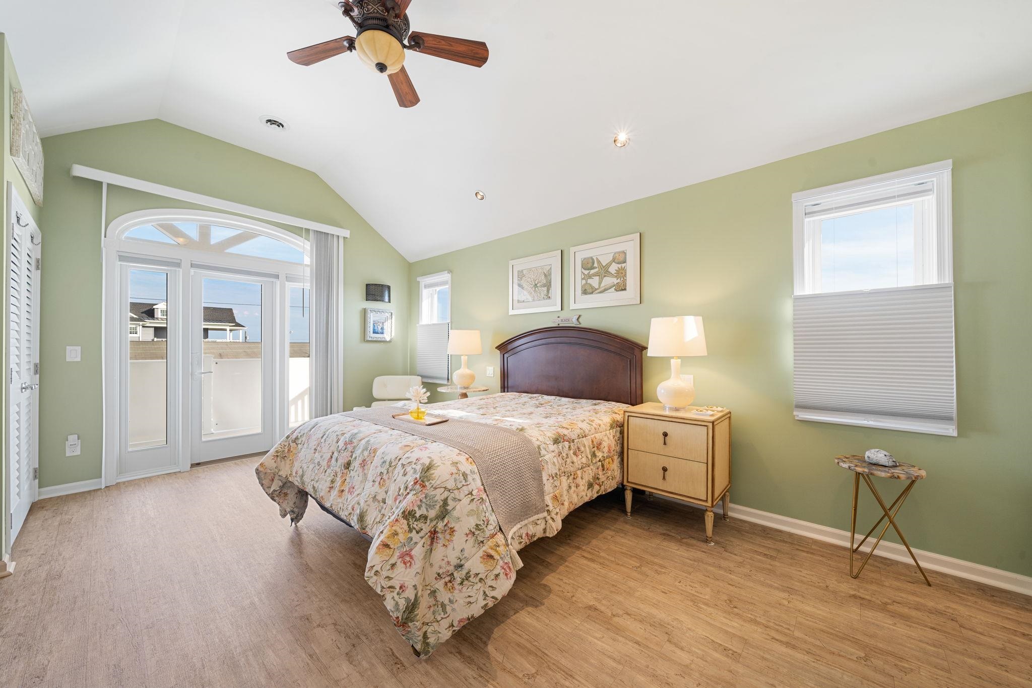 704 South Commonwealth Avenue Strathmere, NJ 08248 - Photo 41 of 50 a bedroom with a bed and a chandelier