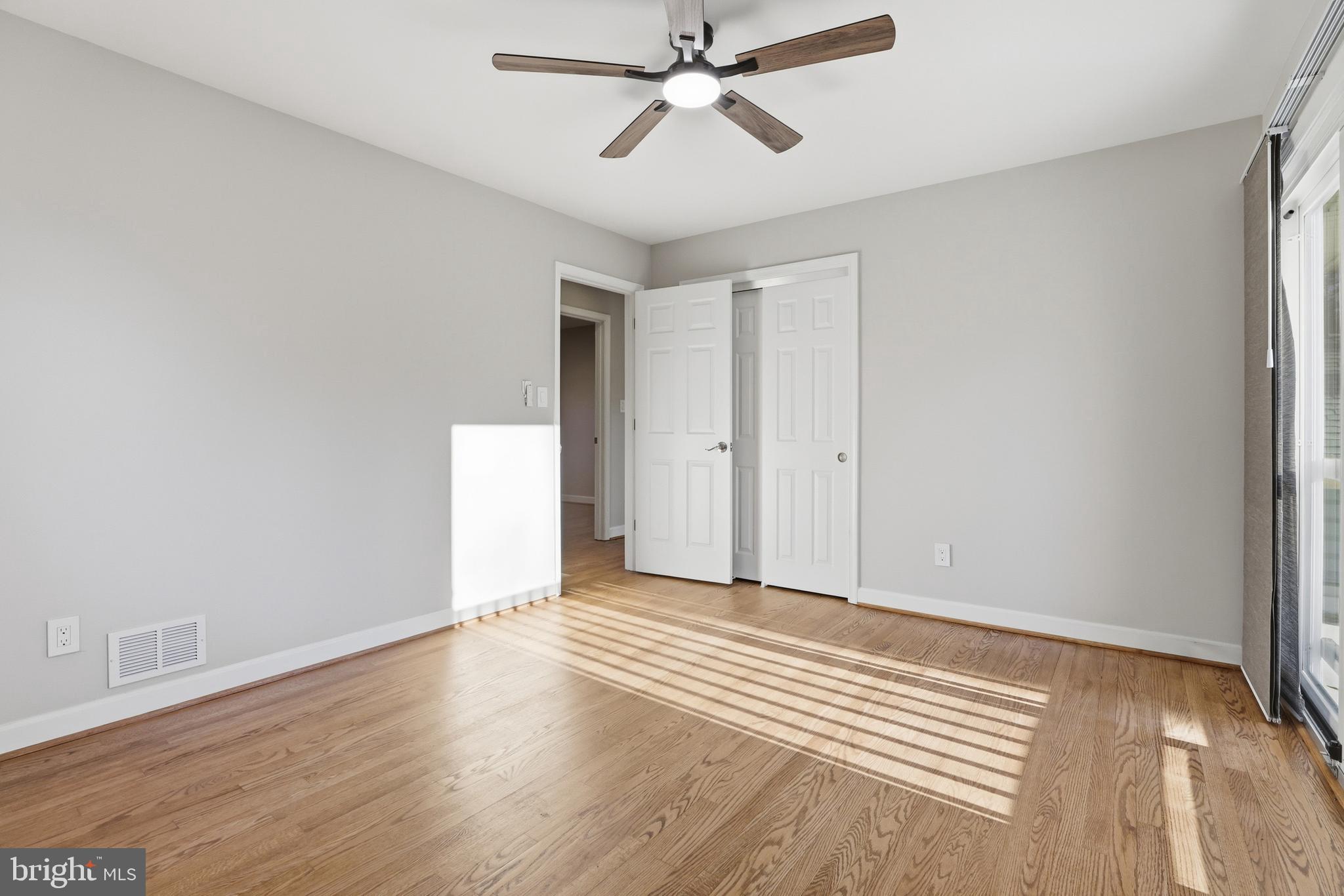 19 Roe Lane Arnold, MD 21012 - Photo 25 of 35 an empty room with wooden floor ceiling fan and windows