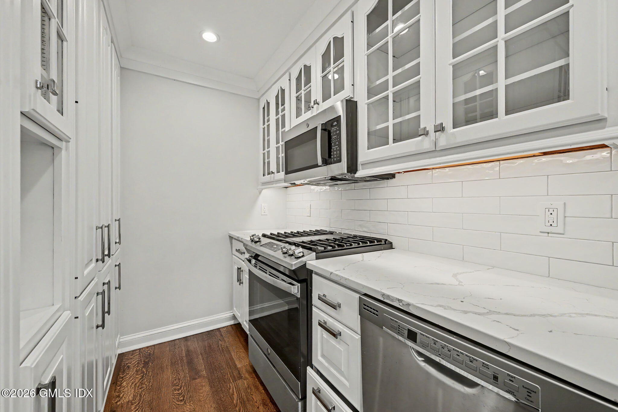 124 Shore Road Old Greenwich, CT 06870 - Photo 7 of 28 a kitchen with stainless steel appliances granite countertop a stove and a microwave