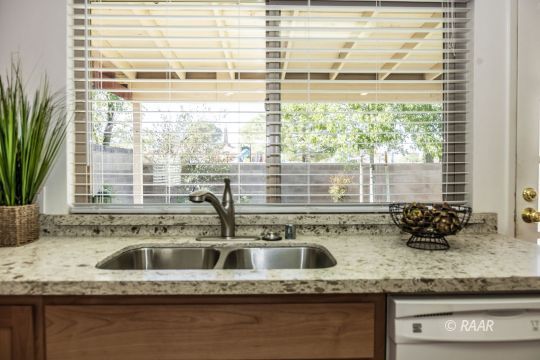 437 Peg Street Ridgecrest, CA 93555 - Photo 5 of 35 a kitchen with granite countertop a sink and a window