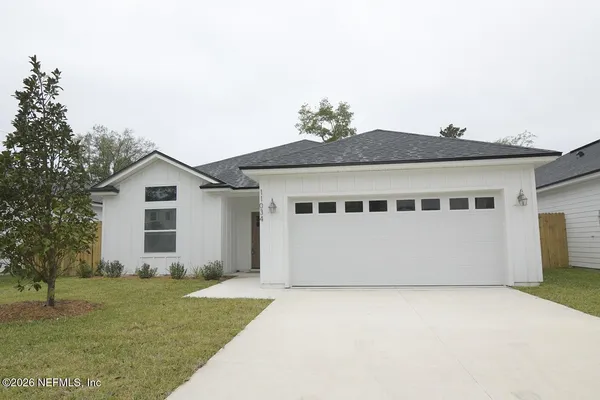 a front view of house with a garden