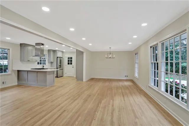 a view of kitchen with windows and refrigerator