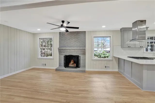 a view of kitchen with granite countertop fireplace and wooden floor