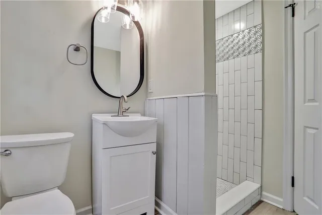 a bathroom with a sink toilet and a mirror