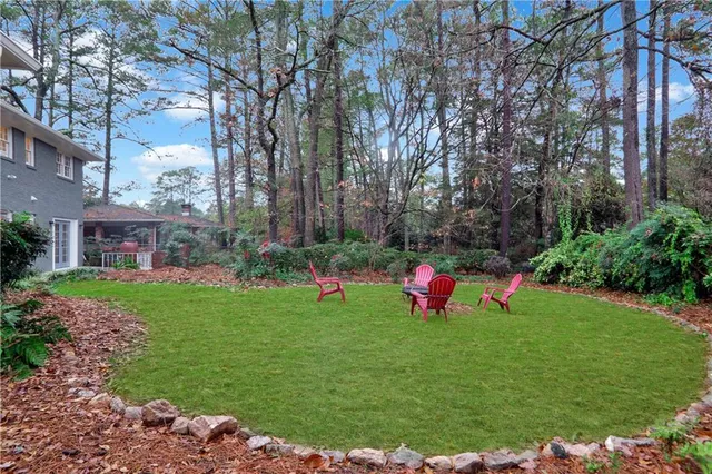 a front view of a house with swing and a tree