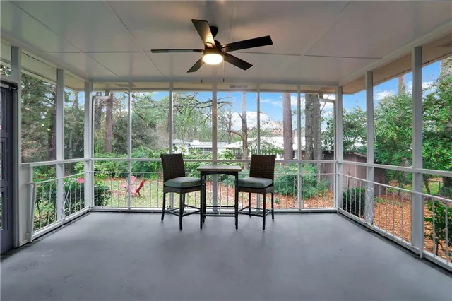 a view of a porch with furniture and a yard