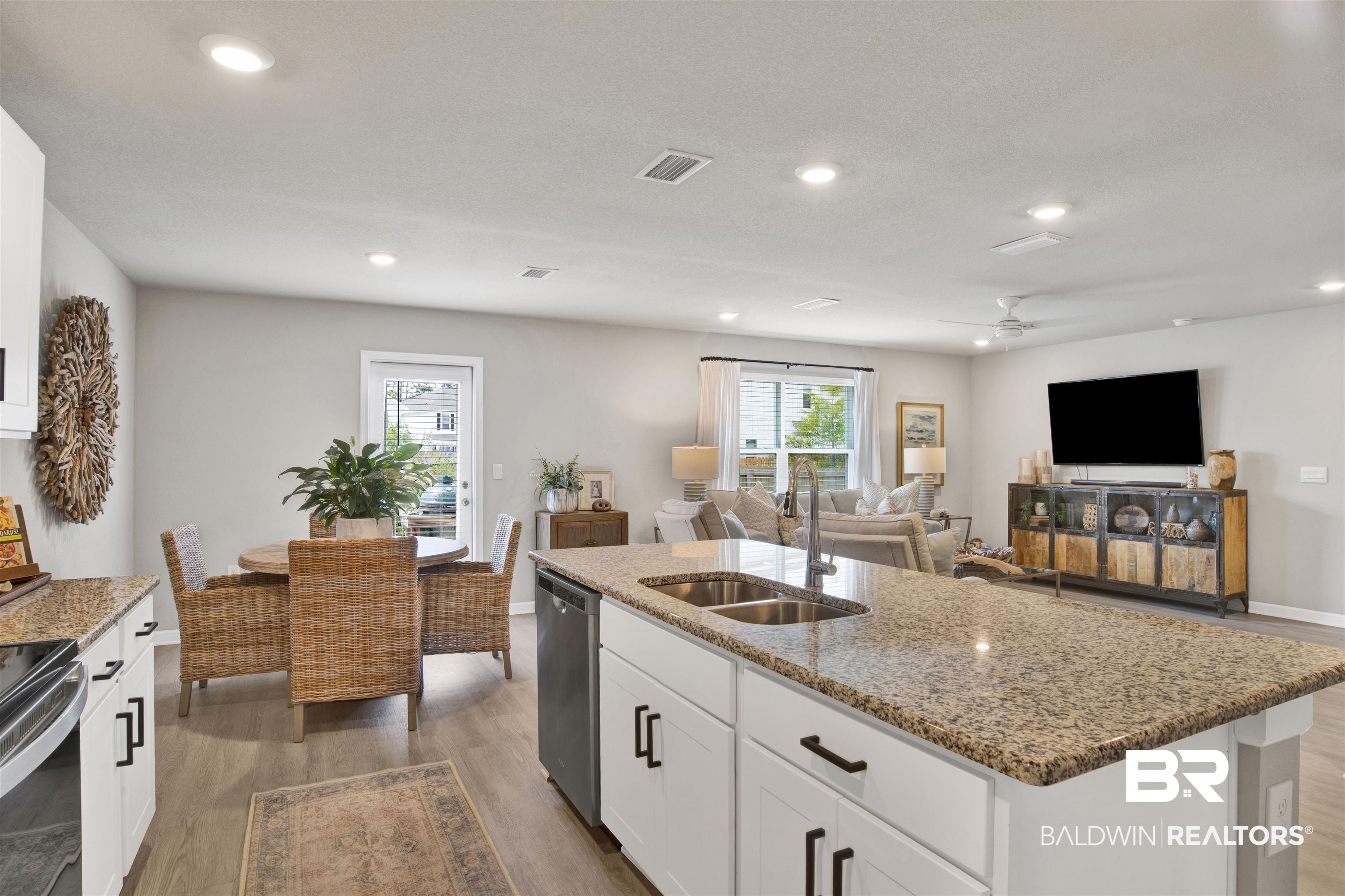 24532 Broken Sound Loop Orange Beach, AL 36561 - Photo 13 of 29 Kitchen with sink, light wood-type flooring, a center island with sink, and ceiling fan