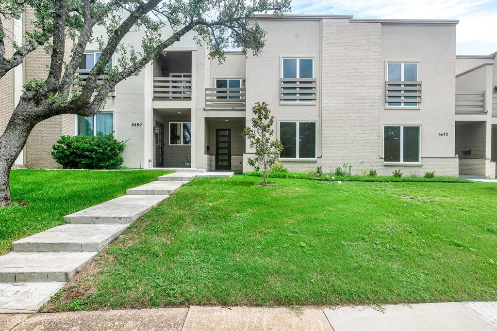 9471 Timberleaf Drive Dallas, TX 75243 - Photo 1 of 39 Modern townhome exterior featuring light brick and stucco finishes