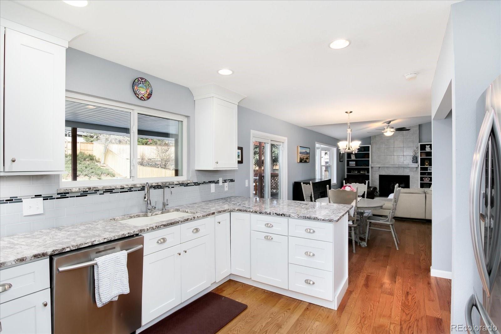 405 Northridge Road Highlands Ranch, CO 80126 - Photo 11 of 40 a kitchen with a sink stove and cabinets