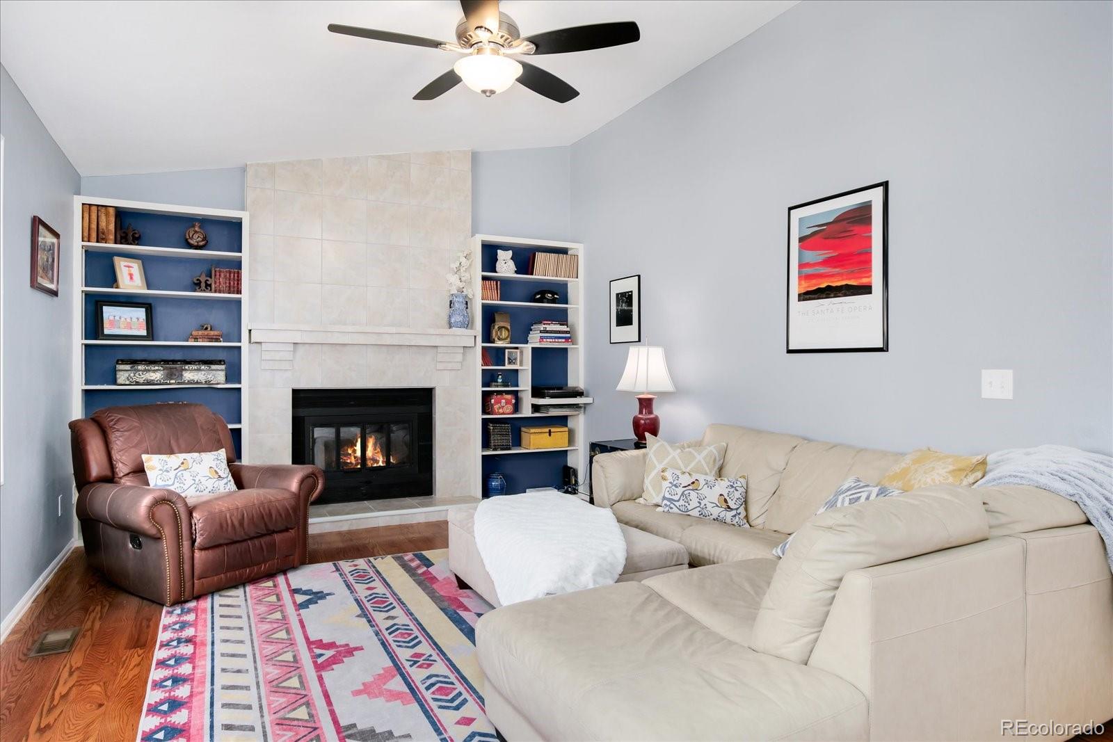 405 Northridge Road Highlands Ranch, CO 80126 - Photo 17 of 40 a living room with furniture and a fireplace