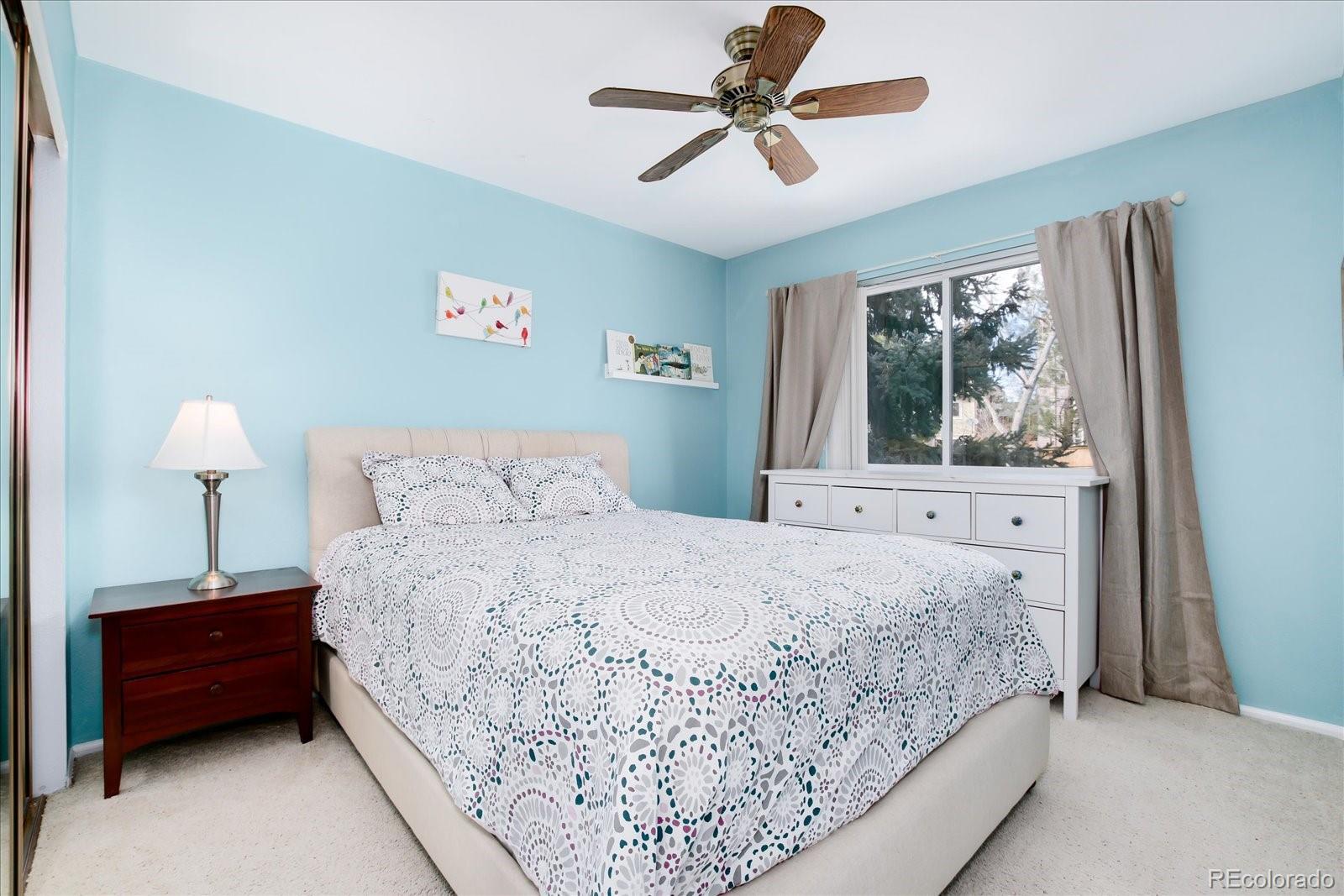 405 Northridge Road Highlands Ranch, CO 80126 - Photo 21 of 40 a bedroom with a large bed and a window