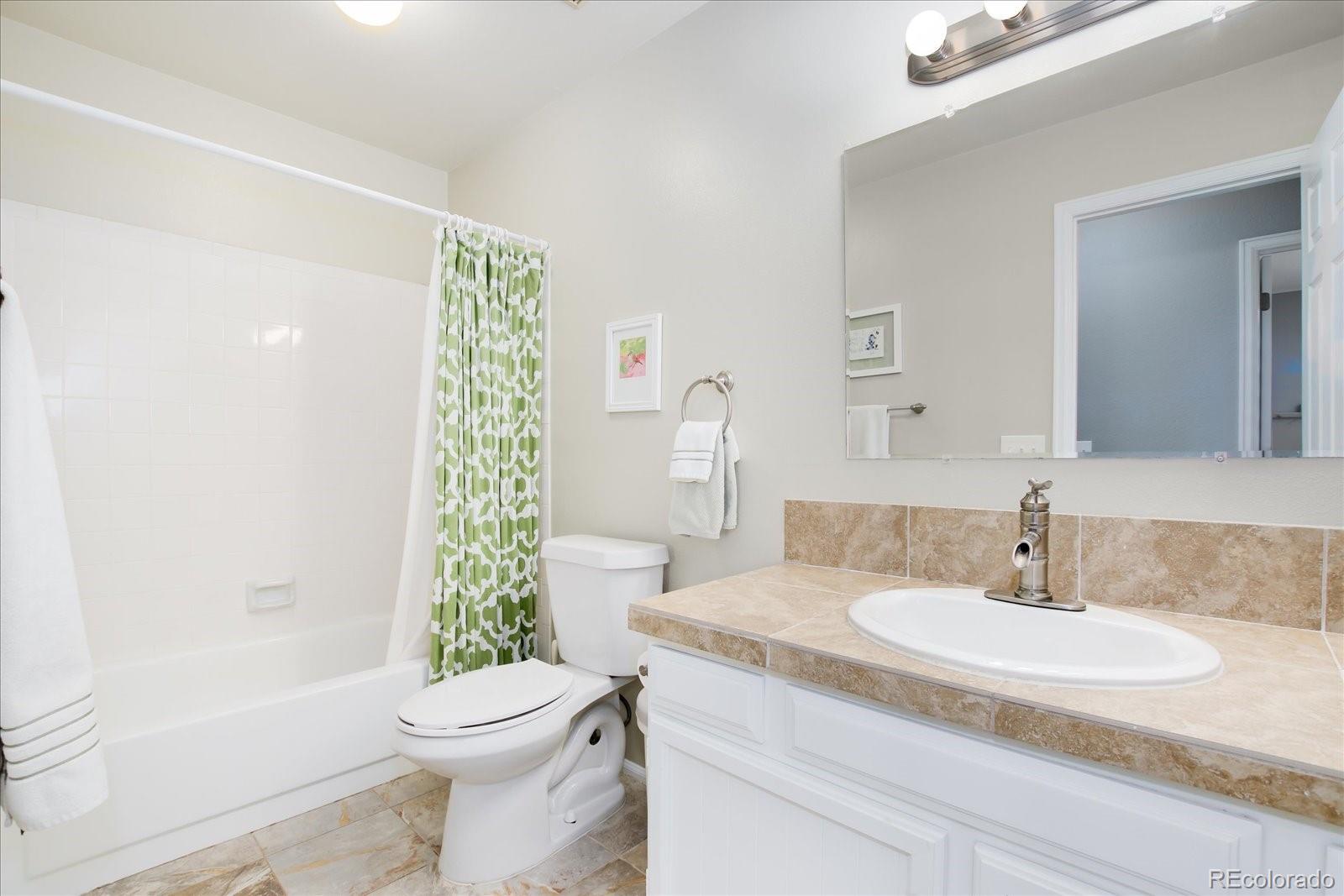 405 Northridge Road Highlands Ranch, CO 80126 - Photo 22 of 40 a bathroom with a granite countertop sink toilet and shower
