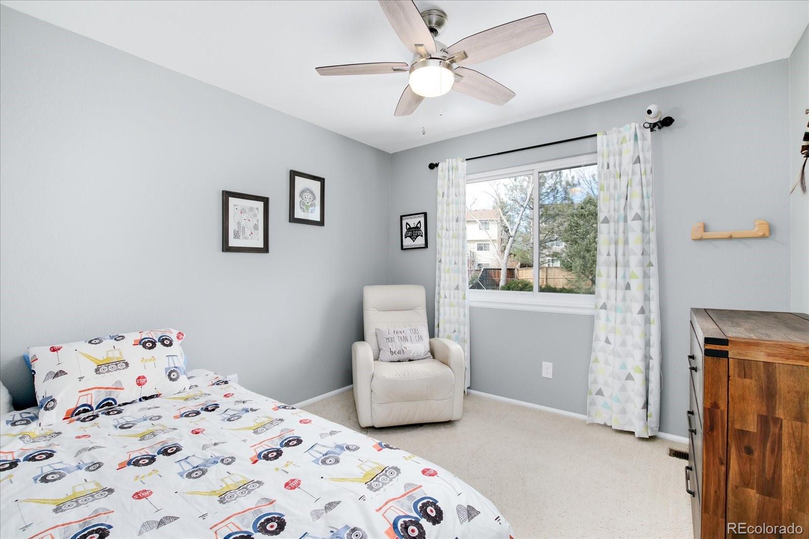 405 Northridge Road Highlands Ranch, CO 80126 - Photo 23 of 40 a bedroom with a bed and wooden floor