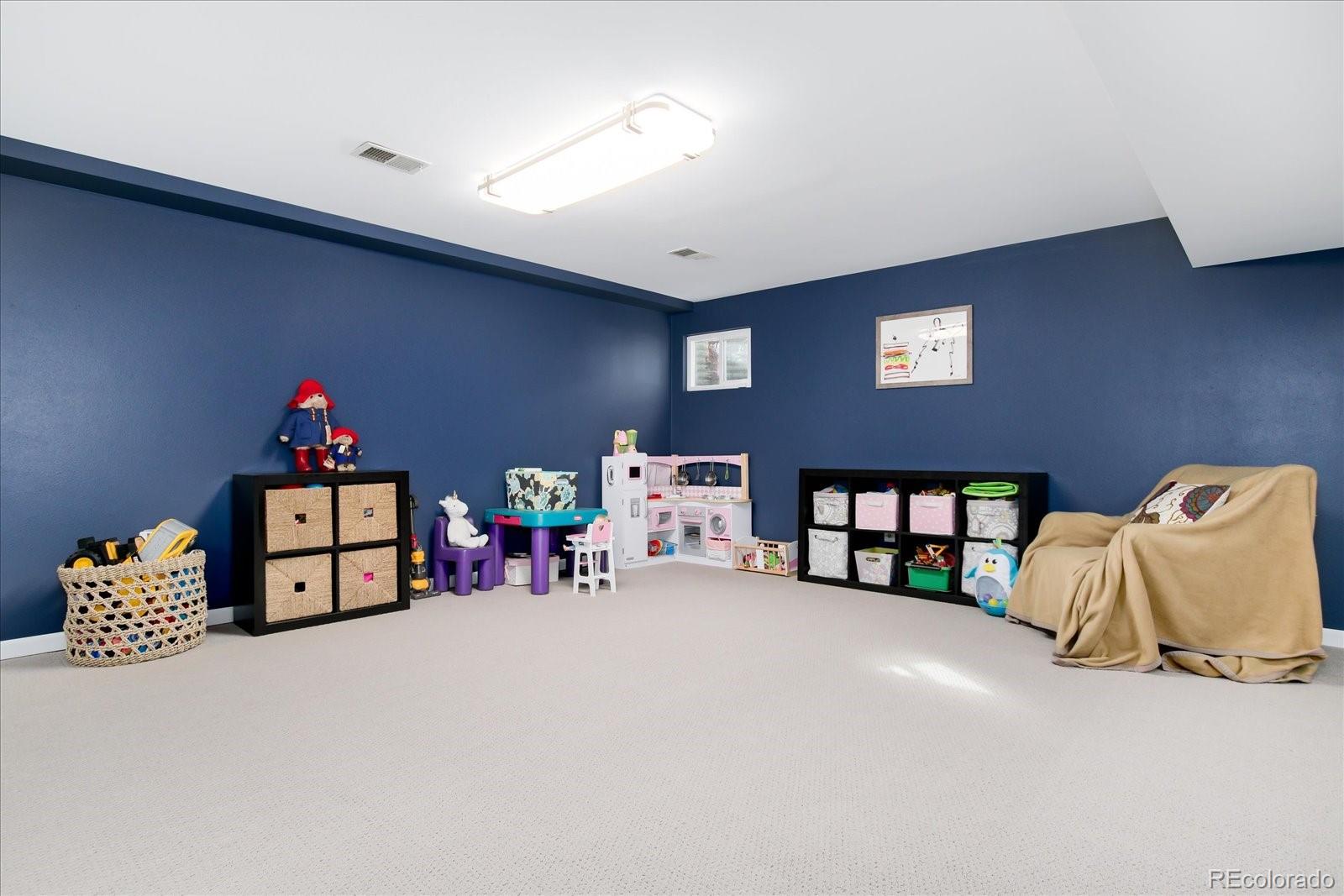 405 Northridge Road Highlands Ranch, CO 80126 - Photo 27 of 40 a bedroom with furniture and a chandelier