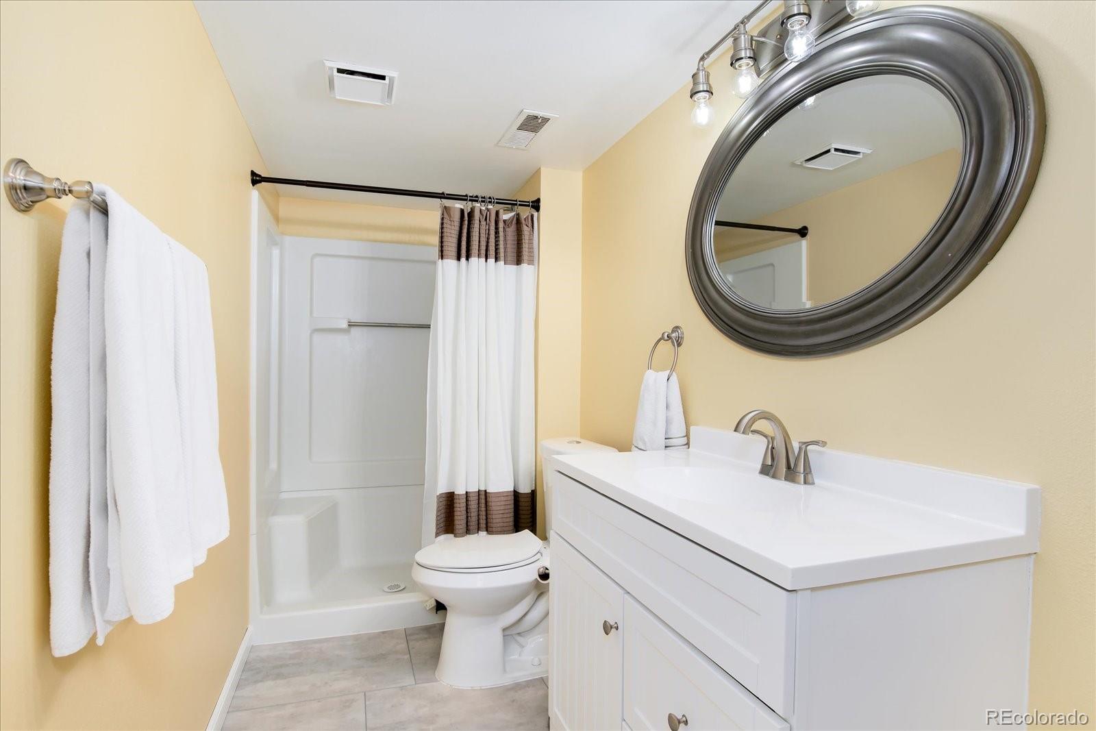 405 Northridge Road Highlands Ranch, CO 80126 - Photo 29 of 40 a bathroom with a sink and a mirror