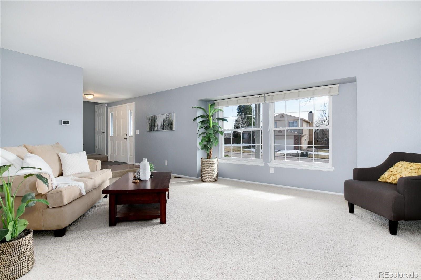405 Northridge Road Highlands Ranch, CO 80126 - Photo 6 of 40 a living room with furniture and a large window