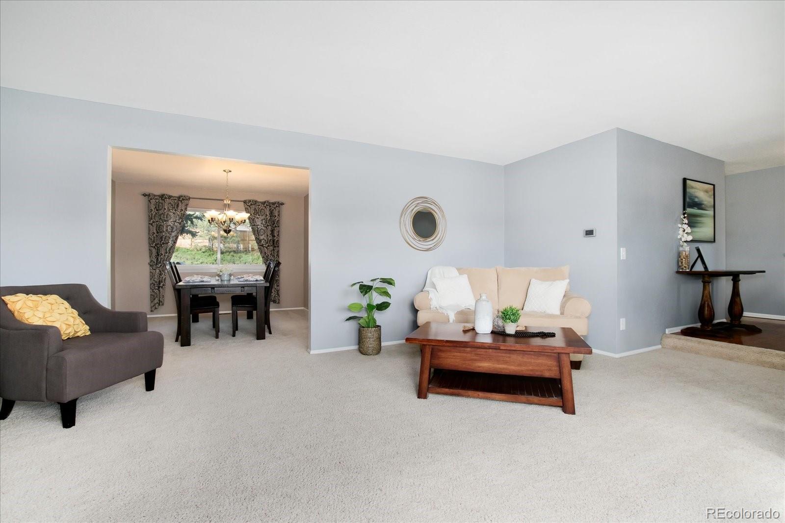 405 Northridge Road Highlands Ranch, CO 80126 - Photo 7 of 40 a living room with furniture and white walls