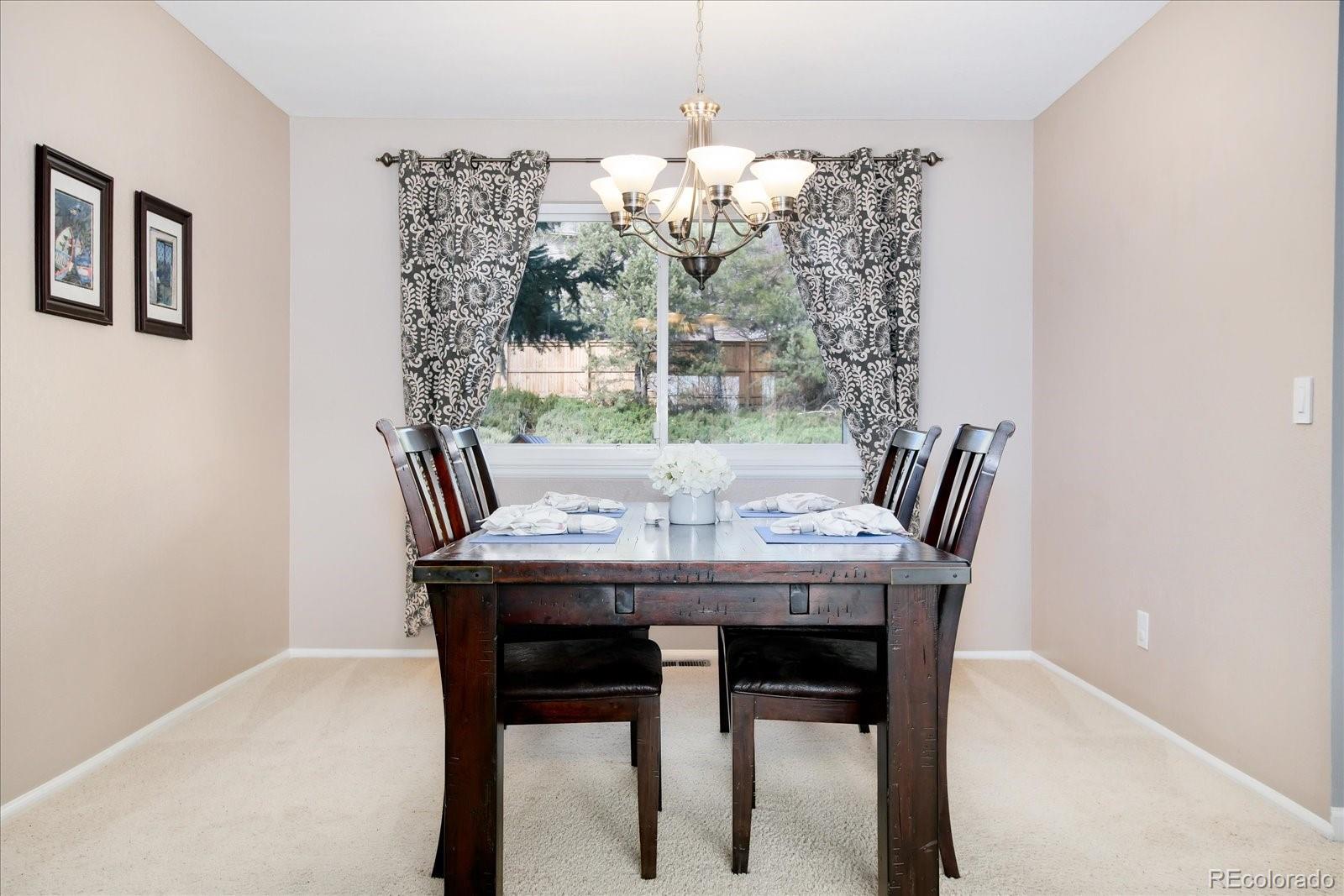 405 Northridge Road Highlands Ranch, CO 80126 - Photo 8 of 40 a view of a dining room with furniture window and outside view