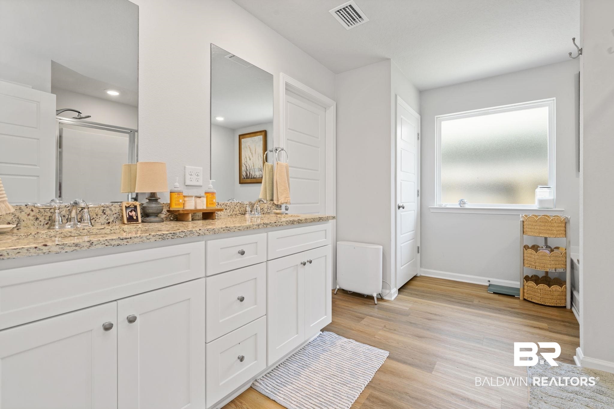 8021 Valor Rdg Way North Mobile, AL 36619 - Photo 28 of 34 Double vanity with a speckled countertop, undermount sinks, and chrome faucets