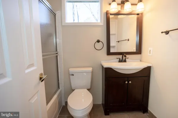 a bathroom with a sink toilet and mirror