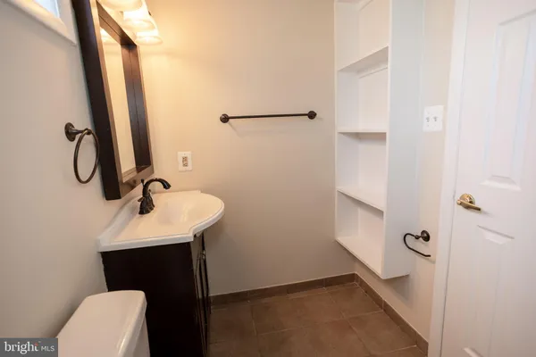 a bathroom with a granite countertop toilet and a shower