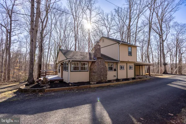 a view of a house with a yard and tree s