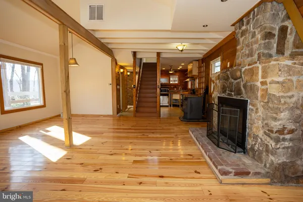 a view of an entryway with wooden floor and door