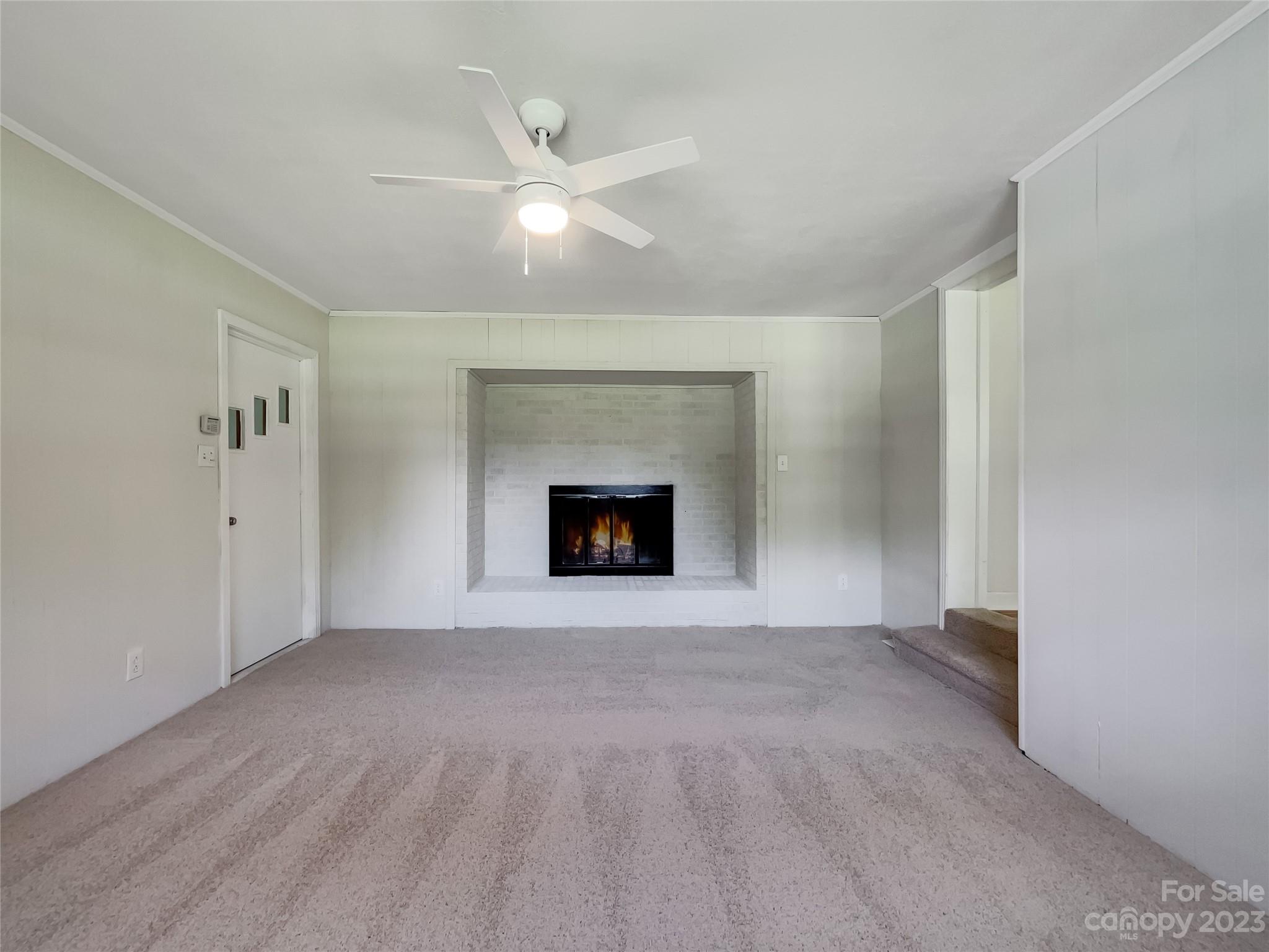4719 Pleasant Grove Road Waxhaw, NC 28173 - Photo 12 of 24 a view of an empty room with a fireplace and a window