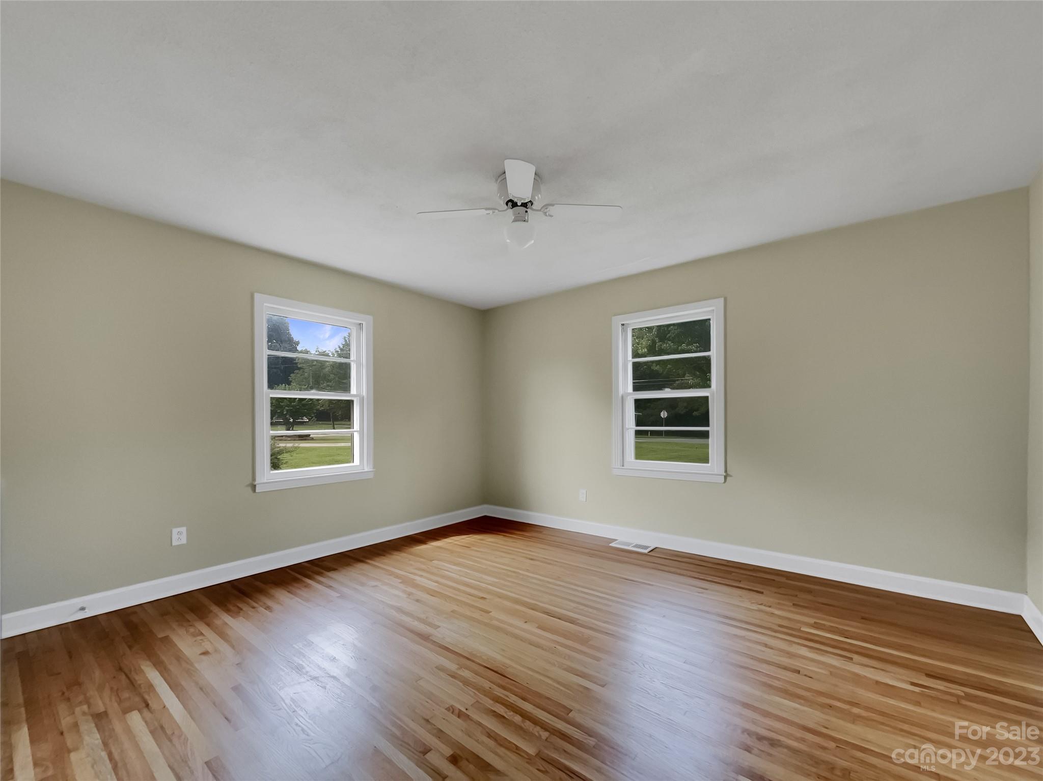 4719 Pleasant Grove Road Waxhaw, NC 28173 - Photo 15 of 24 a view of an empty room with wooden floor and a window