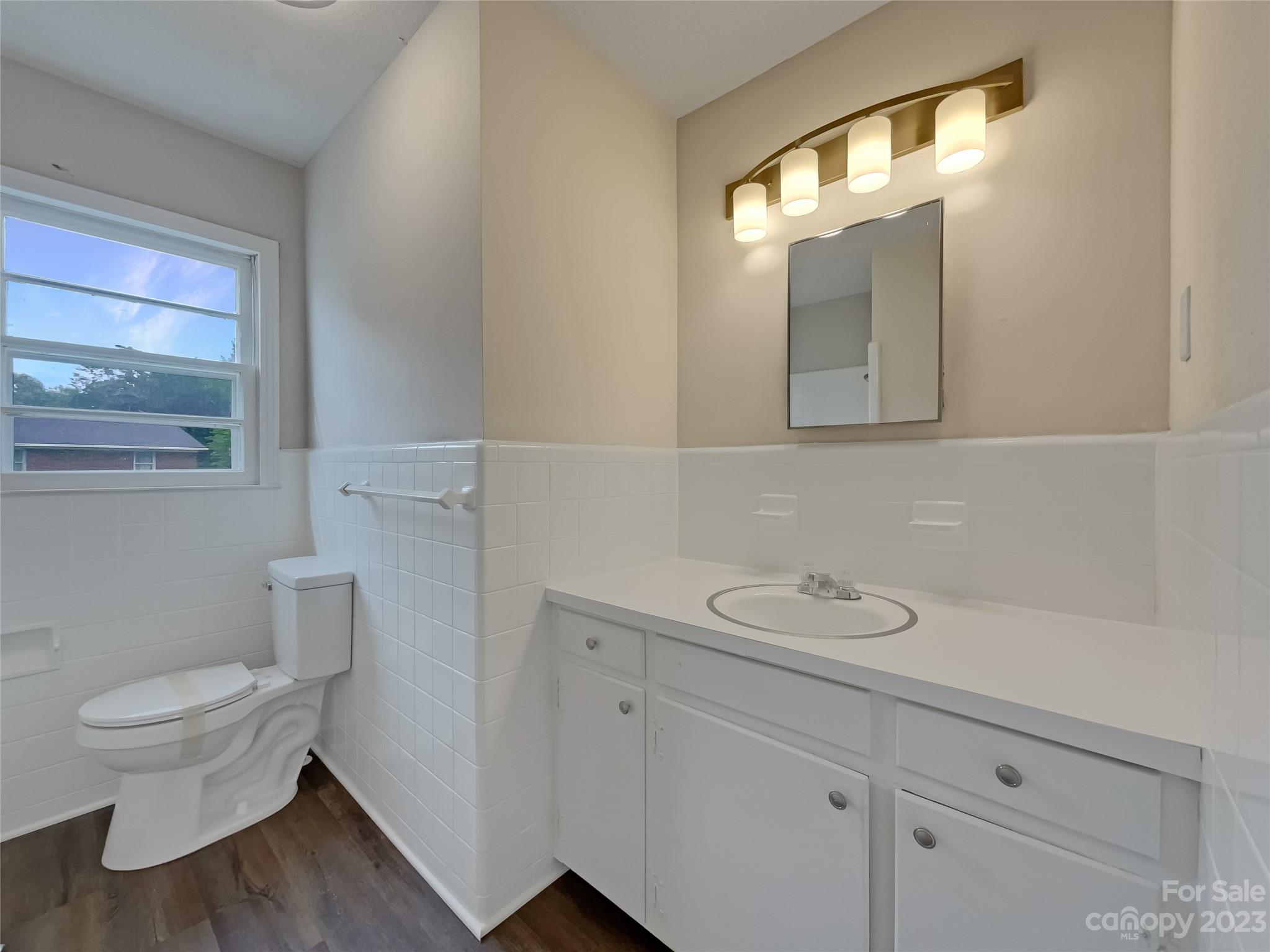4719 Pleasant Grove Road Waxhaw, NC 28173 - Photo 17 of 24 a bathroom with a toilet sink and mirror