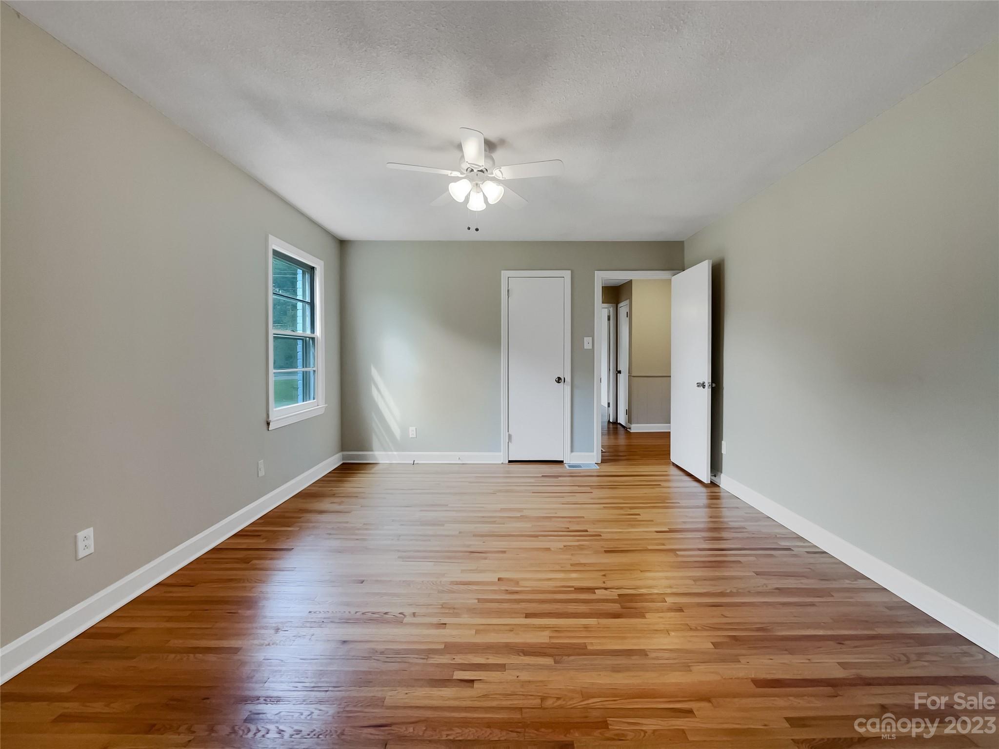 4719 Pleasant Grove Road Waxhaw, NC 28173 - Photo 18 of 24 a view of an empty room with window and wooden floor