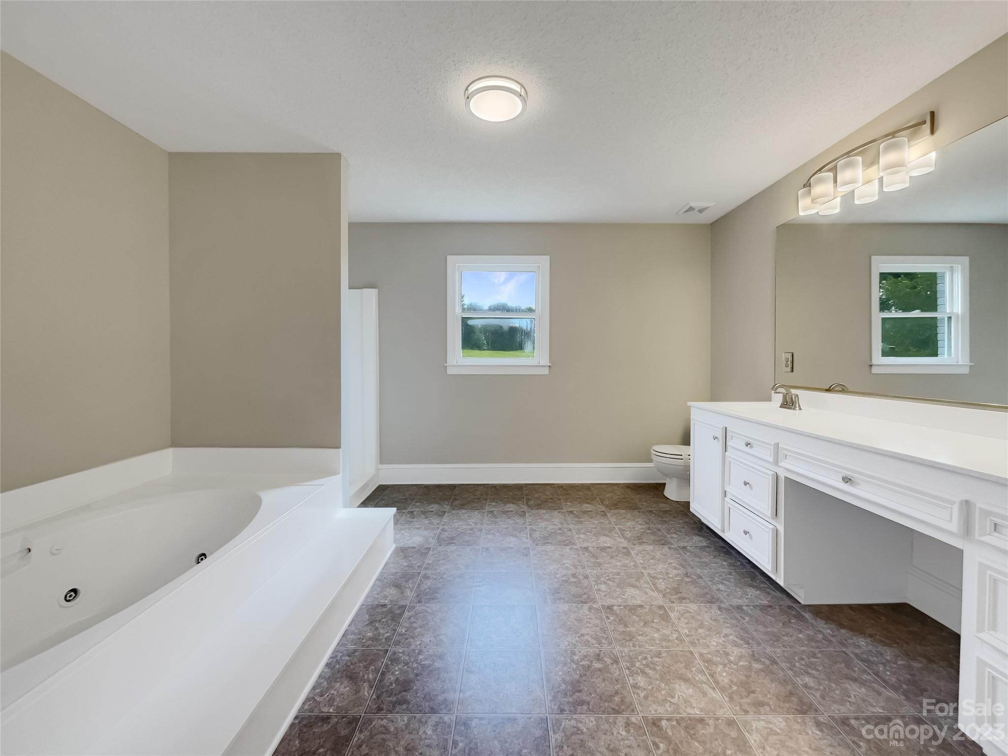 4719 Pleasant Grove Road Waxhaw, NC 28173 - Photo 20 of 24 a bathroom with a tub sink and mirror