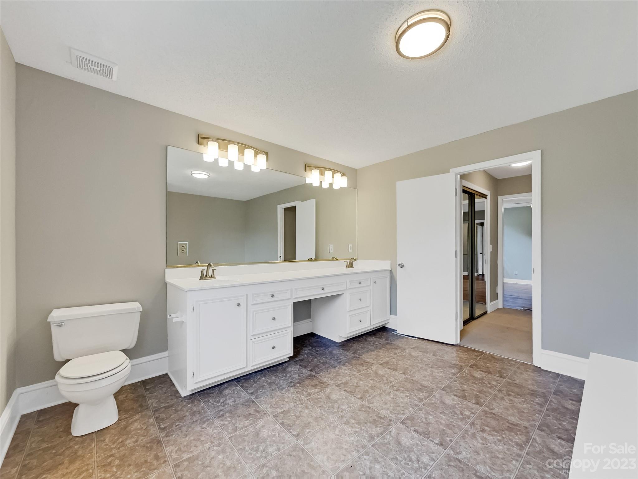 4719 Pleasant Grove Road Waxhaw, NC 28173 - Photo 21 of 24 a bathroom with a toilet sink and mirror