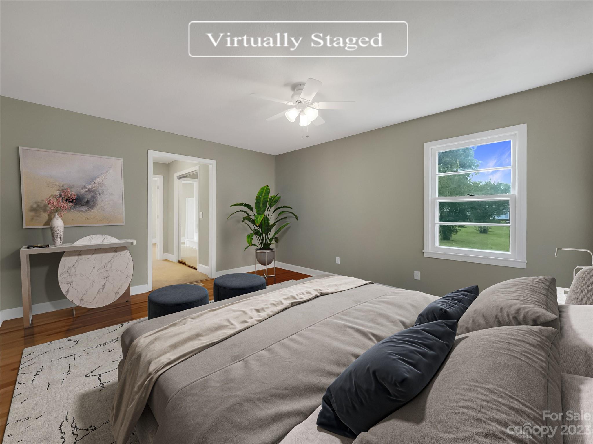 4719 Pleasant Grove Road Waxhaw, NC 28173 - Photo 4 of 24 a bedroom with a bed and a chandelier