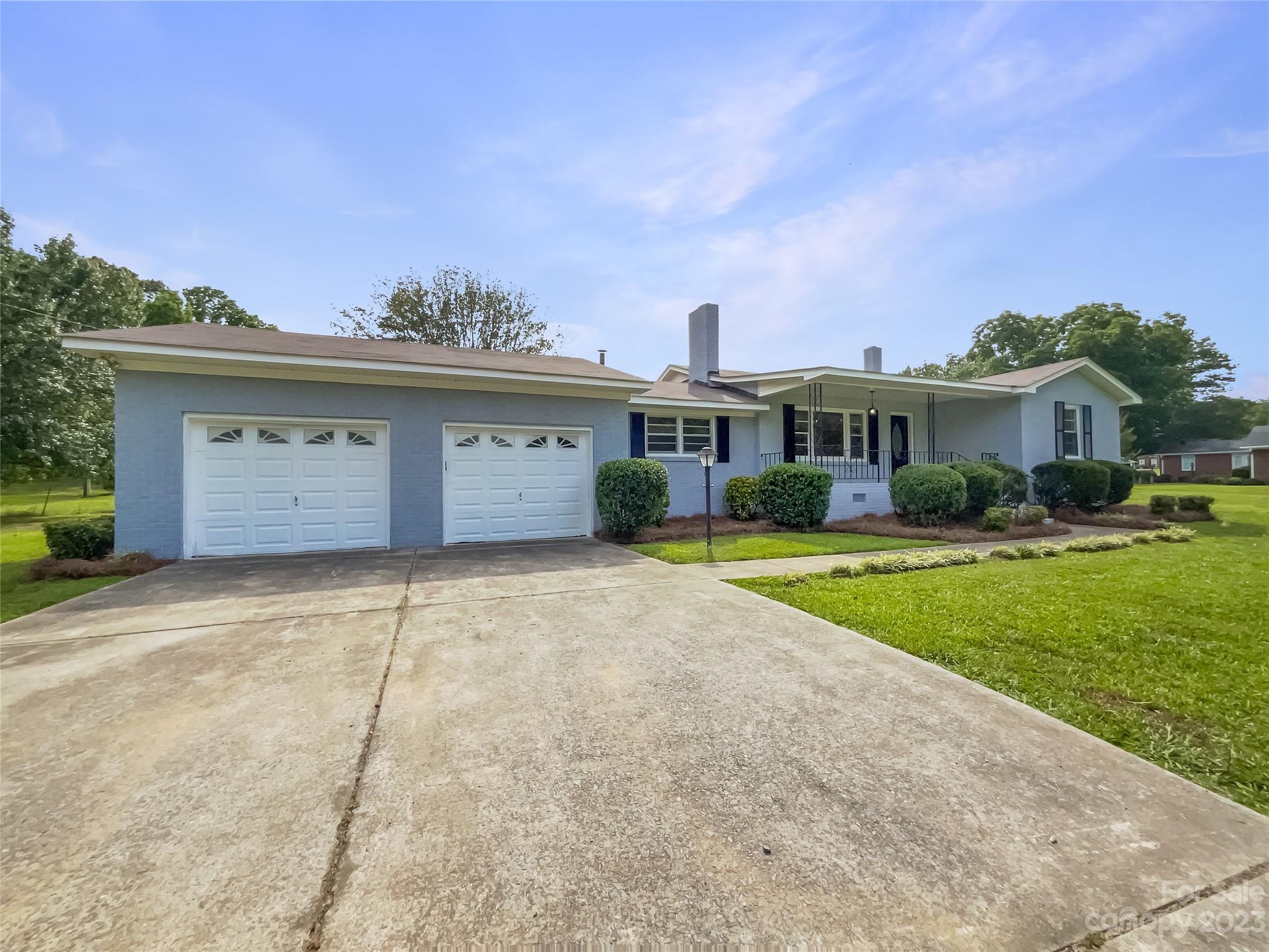 4719 Pleasant Grove Road Waxhaw, NC 28173 - Photo 7 of 24 a front view of a house with a yard and garage