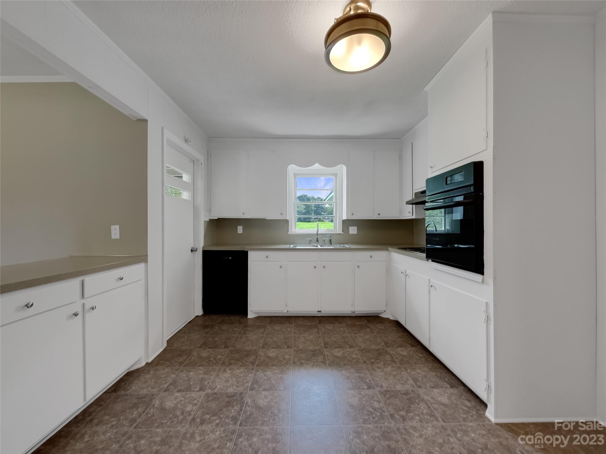 4719 Pleasant Grove Road Waxhaw, NC 28173 - Photo 10 of 24 a kitchen with cabinets and window