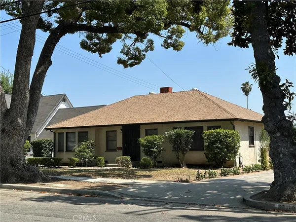 a view of a house with a yard and tree s