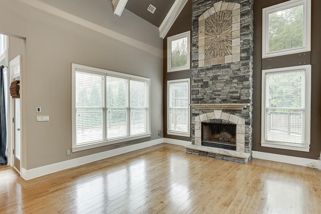 940 Chateau Forest Road Hoschton, GA 30548 - Photo 17 of 87 a view of an empty room with a fireplace and a window